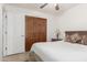 Bedroom with a ceiling fan, wooden floor, closet, and good light at 9809 W Behrend Dr, Peoria, AZ 85382