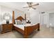Beautiful bedroom featuring tan tile floor, ceiling fan, and wooden four poster bed frame at 9809 W Behrend Dr, Peoria, AZ 85382