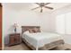 Comfortable bedroom with ceiling fan, tan carpet, and natural light at 9809 W Behrend Dr, Peoria, AZ 85382