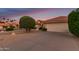 Beautiful home featuring a two-car garage, well-maintained desert landscaping, and a classic red tile roof at 9809 W Behrend Dr, Peoria, AZ 85382
