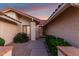 Inviting home entrance with a decorative security door, desert landscaping, and a charming facade at 9809 W Behrend Dr, Peoria, AZ 85382