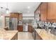 Updated kitchen featuring custom cabinets, stainless steel appliances, granite countertops, and decorative backsplash at 9809 W Behrend Dr, Peoria, AZ 85382