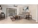 Comfortable living room featuring a plush sofa, stylish decor, and sliding glass doors to the backyard at 9809 W Behrend Dr, Peoria, AZ 85382