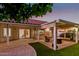 Inviting covered patio with fire pit and seating area at 9809 W Behrend Dr, Peoria, AZ 85382