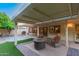 Inviting covered patio with fire pit, seating area, and outdoor grill at 9809 W Behrend Dr, Peoria, AZ 85382