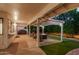 Inviting covered patio with fire pit and seating area at 9809 W Behrend Dr, Peoria, AZ 85382