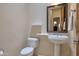 Powder room featuring pedestal sink, toilet, mirror and two floating shelves at 9847 E Preserve Way, Scottsdale, AZ 85262
