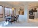 Elegant dining room featuring a modern chandelier, dark wood table and travertine flooring at 9847 E Preserve Way, Scottsdale, AZ 85262
