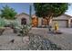 Charming home with desert landscaping featuring cacti, stones, and mature trees at 9847 E Preserve Way, Scottsdale, AZ 85262