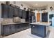 Modern kitchen featuring granite countertops, black cabinets, tile backsplash and tile flooring at 9847 E Preserve Way, Scottsdale, AZ 85262