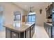 Well-appointed kitchen with an island, granite countertops, and dark cabinetry at 9847 E Preserve Way, Scottsdale, AZ 85262
