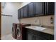 Laundry room boasts sleek cabinetry, modern washer/dryer units, and ample counter space at 9847 E Preserve Way, Scottsdale, AZ 85262
