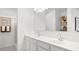 Bright bathroom featuring double sinks, a large mirror, and contemporary fixtures at 10524 W Bloch Rd, Tolleson, AZ 85353