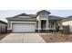 Charming single-story home featuring a two-car garage, well-manicured landscaping, and a welcoming entrance at 10524 W Bloch Rd, Tolleson, AZ 85353