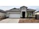 Attractive one-story home featuring an attached two-car garage, manicured yard, and welcoming front entry at 10524 W Bloch Rd, Tolleson, AZ 85353