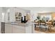 Stylish kitchen island with stainless steel sink overlooking the dining area and living room at 10524 W Bloch Rd, Tolleson, AZ 85353