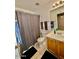 Functional bathroom with tiled floors, wood vanity, and neutral-colored shower curtain at 10705 W Montecito Ave, Phoenix, AZ 85037