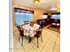 Cozy dining area adjacent to the living room, featuring a floral tablecloth and seating for four at 10705 W Montecito Ave, Phoenix, AZ 85037