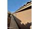Side view of the home showing the stucco exterior and well-maintained walkway at 10705 W Montecito Ave, Phoenix, AZ 85037