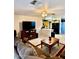 Spacious living room with tile flooring, ceiling fan, and easy access to the kitchen at 10705 W Montecito Ave, Phoenix, AZ 85037