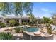 Backyard featuring a sparkling pool, lush landscaping, and a luxurious outdoor living space at 11717 E Estrella Ave, Scottsdale, AZ 85259