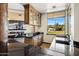 Wet bar area featuring a granite countertop, wood cabinets and a large window with beautiful outdoor views at 11717 E Estrella Ave, Scottsdale, AZ 85259