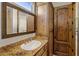Classic bathroom features a granite countertop, built-in cabinets, and decorative mirror at 11717 E Estrella Ave, Scottsdale, AZ 85259