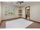 Empty bedroom with neutral walls, corner shelves, and a view into the ensuite bathroom at 11717 E Estrella Ave, Scottsdale, AZ 85259