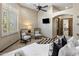 Well-lit bedroom with large windows, ceiling fan, and sitting area with neutral decor at 11717 E Estrella Ave, Scottsdale, AZ 85259