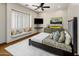Comfortable bedroom features a window seat, ceiling fan, and unique decorative accents at 11717 E Estrella Ave, Scottsdale, AZ 85259