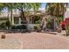 Front exterior of home with brick driveway, stone entry, and lush landscaping at 11717 E Estrella Ave, Scottsdale, AZ 85259