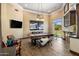 Stylish game room featuring a pool table, sitting area, and wet bar with beautiful backyard views at 11717 E Estrella Ave, Scottsdale, AZ 85259
