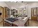 Gourmet kitchen with large island, gas cooktop, and breakfast bar overlooking an outdoor patio at 11717 E Estrella Ave, Scottsdale, AZ 85259