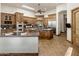 Open kitchen with stainless steel appliances, custom cabinetry, granite counters, and wood flooring at 11717 E Estrella Ave, Scottsdale, AZ 85259
