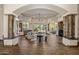 Open-concept living space with wood floors, stone pillars, a fireplace, and access to the outdoor spaces at 11717 E Estrella Ave, Scottsdale, AZ 85259