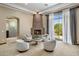 Comfortable living room featuring a fireplace and elegant seating arrangement at 11717 E Estrella Ave, Scottsdale, AZ 85259