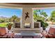Enjoy the desert landscape with a stucco outdoor fireplace and lounge seating at 11717 E Estrella Ave, Scottsdale, AZ 85259