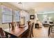 Bright dining room with decorative chandelier, hardwood table, and views of the living room at 17874 N 93Rd Way, Scottsdale, AZ 85255