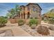Two-story home showcasing a stucco exterior, private balcony, and desert landscaping at 17874 N 93Rd Way, Scottsdale, AZ 85255