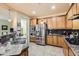 Modern kitchen with stainless steel appliances, granite countertops, and custom wood cabinets at 17874 N 93Rd Way, Scottsdale, AZ 85255