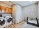 Convenient laundry room with a washer, dryer, storage cabinets, and tiled floors at 17874 N 93Rd Way, Scottsdale, AZ 85255