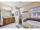 Luxurious main bathroom with a soaking tub, walk-in shower, and dual sink vanity at 17874 N 93Rd Way, Scottsdale, AZ 85255