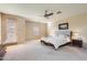 Spacious main bedroom features a ceiling fan, plush carpet, and an exterior door at 17874 N 93Rd Way, Scottsdale, AZ 85255