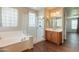 Bathroom featuring a tub and frameless glass walk-in shower at 18283 N 93Rd St, Scottsdale, AZ 85255