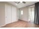 Bedroom with sliding closet doors and backyard access at 18283 N 93Rd St, Scottsdale, AZ 85255