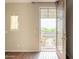Bright bedroom featuring hardwood floors, a window and french doors leading to a patio and beautiful natural light at 18283 N 93Rd St, Scottsdale, AZ 85255