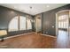 Stylish dining room featuring a decorative accent wall, modern lighting, and wood-look floors at 18283 N 93Rd St, Scottsdale, AZ 85255