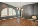 Elegant dining space with statement wallpaper, modern chandelier, and beautiful wood-look flooring at 18283 N 93Rd St, Scottsdale, AZ 85255
