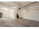 Spacious and well-lit two car garage with ample room for vehicles and storage, plus a side door to the exterior at 18283 N 93Rd St, Scottsdale, AZ 85255