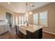 Open-concept kitchen showcasing a large island, farmhouse sink, and stylish pendant lighting at 18283 N 93Rd St, Scottsdale, AZ 85255